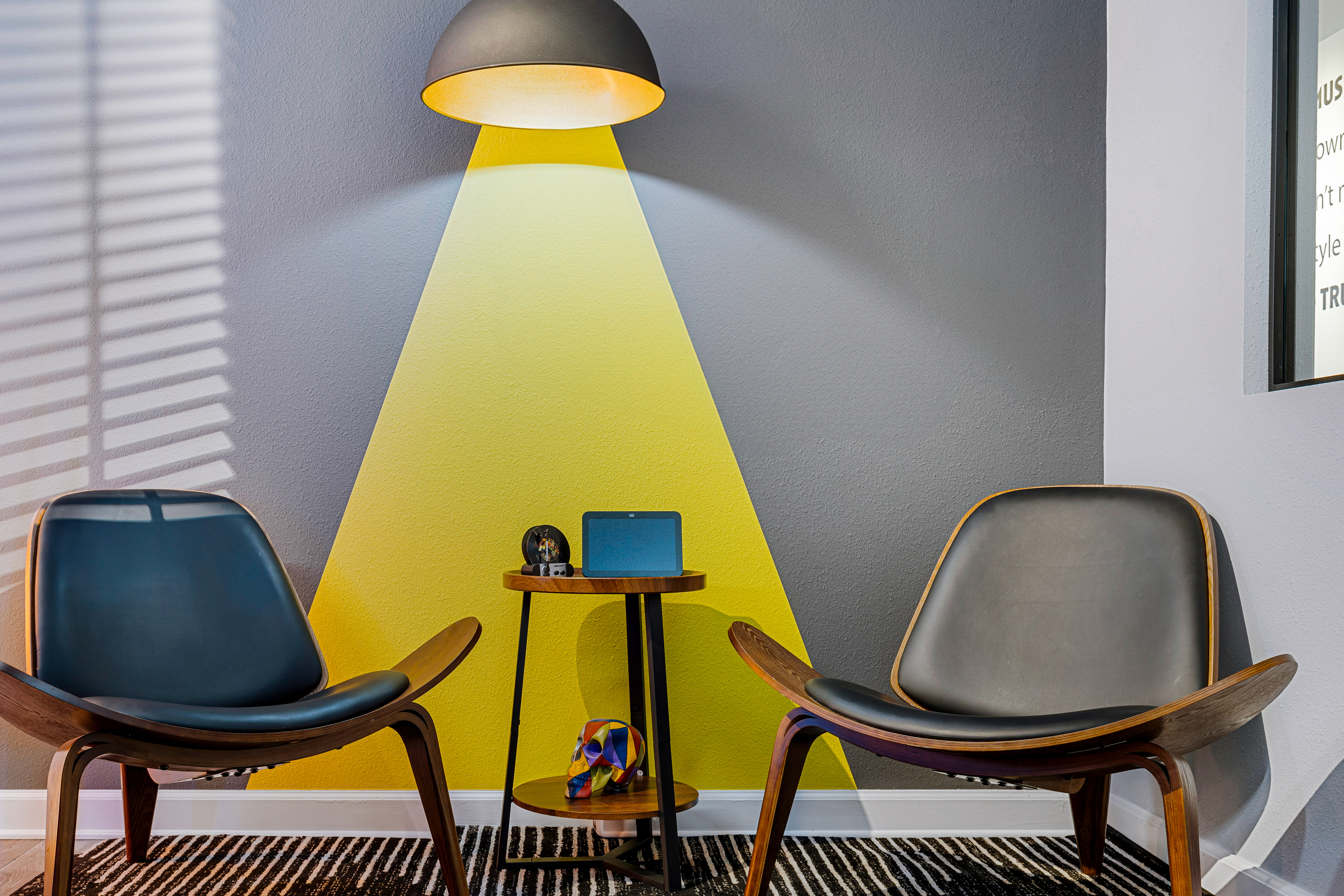 Seating corner with a yellow geometric wall detail